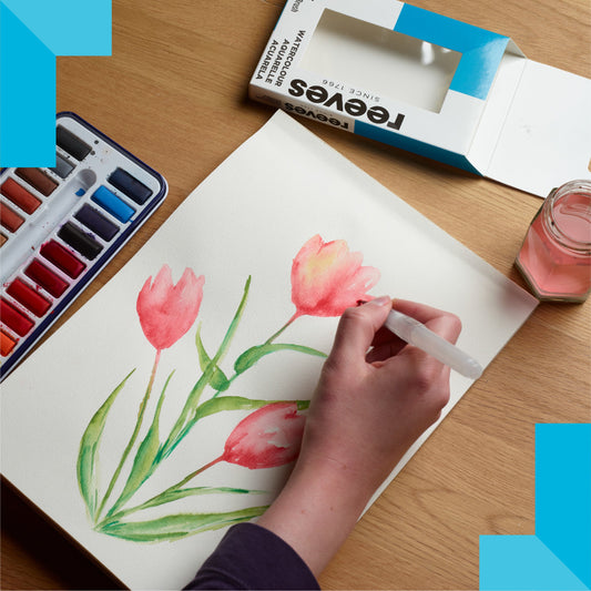 close of paper where a person is painting a watercolour flower