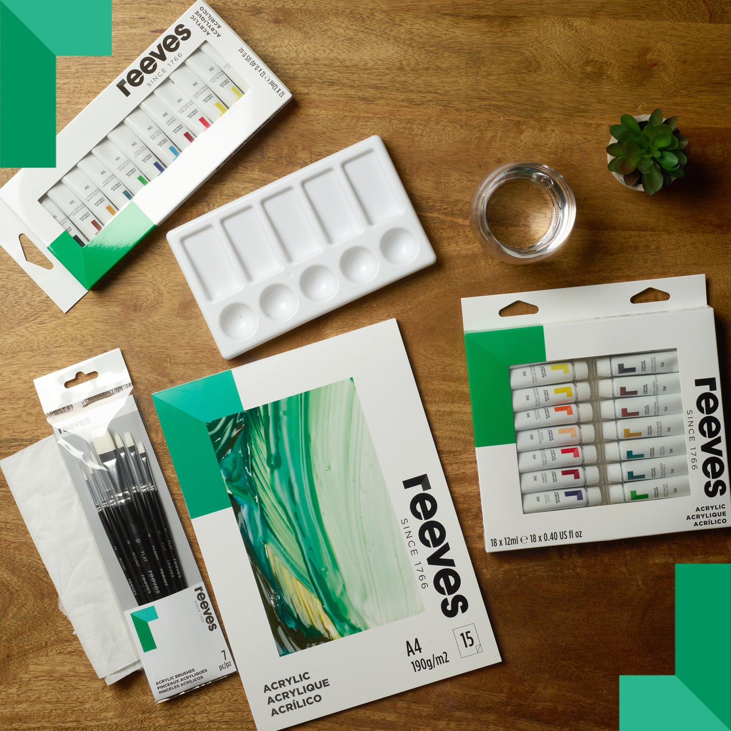 Reeves art supplies including paint tubes, brushes, and a palette on a wooden surface.
